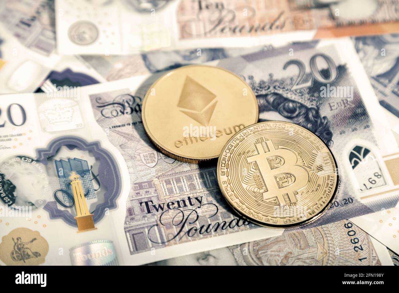 Cryptocurrency bitcoin and ether (ethereum) token coins against British Ponuds GBP Stock Photo
