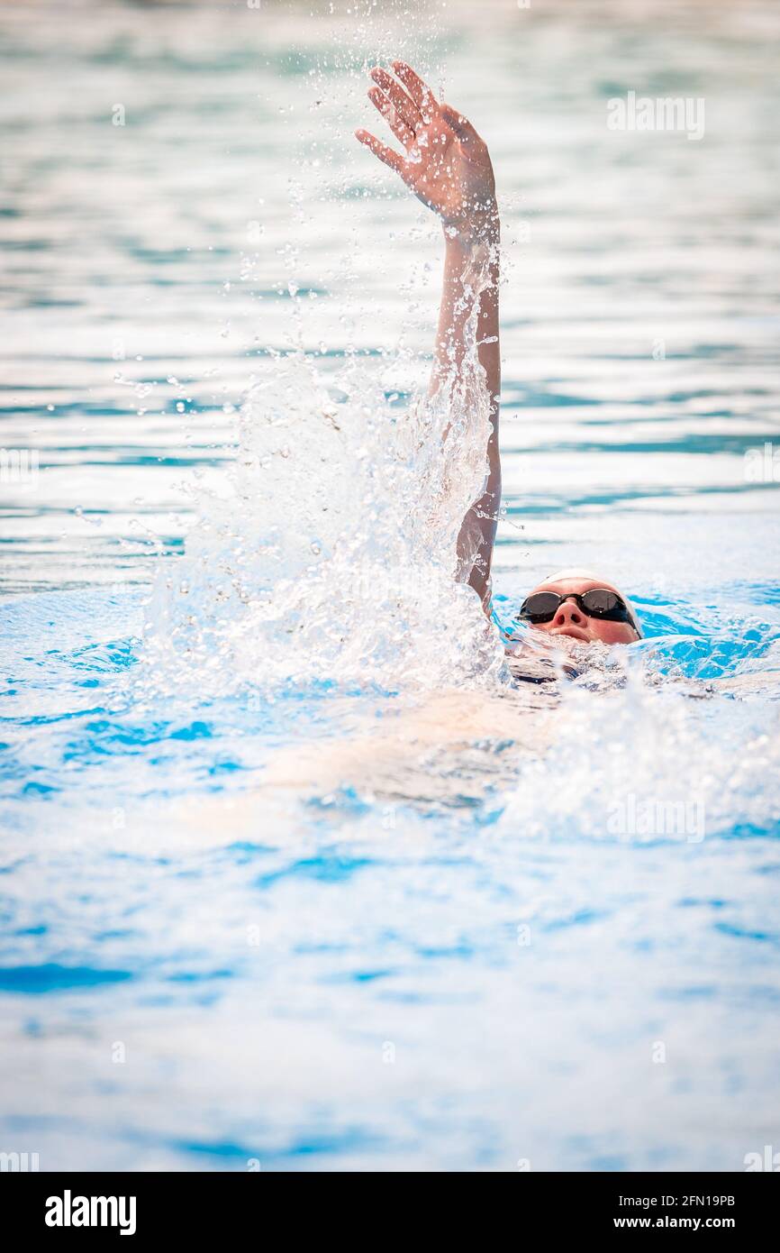 Hanover, Germany. 13th May, 2021. A woman swims in a pool of the outdoor  swimming pool Lister Bad. Hannover opens the outdoor swimming season from  today, Thursday (13.05.2021). However, special rules apply