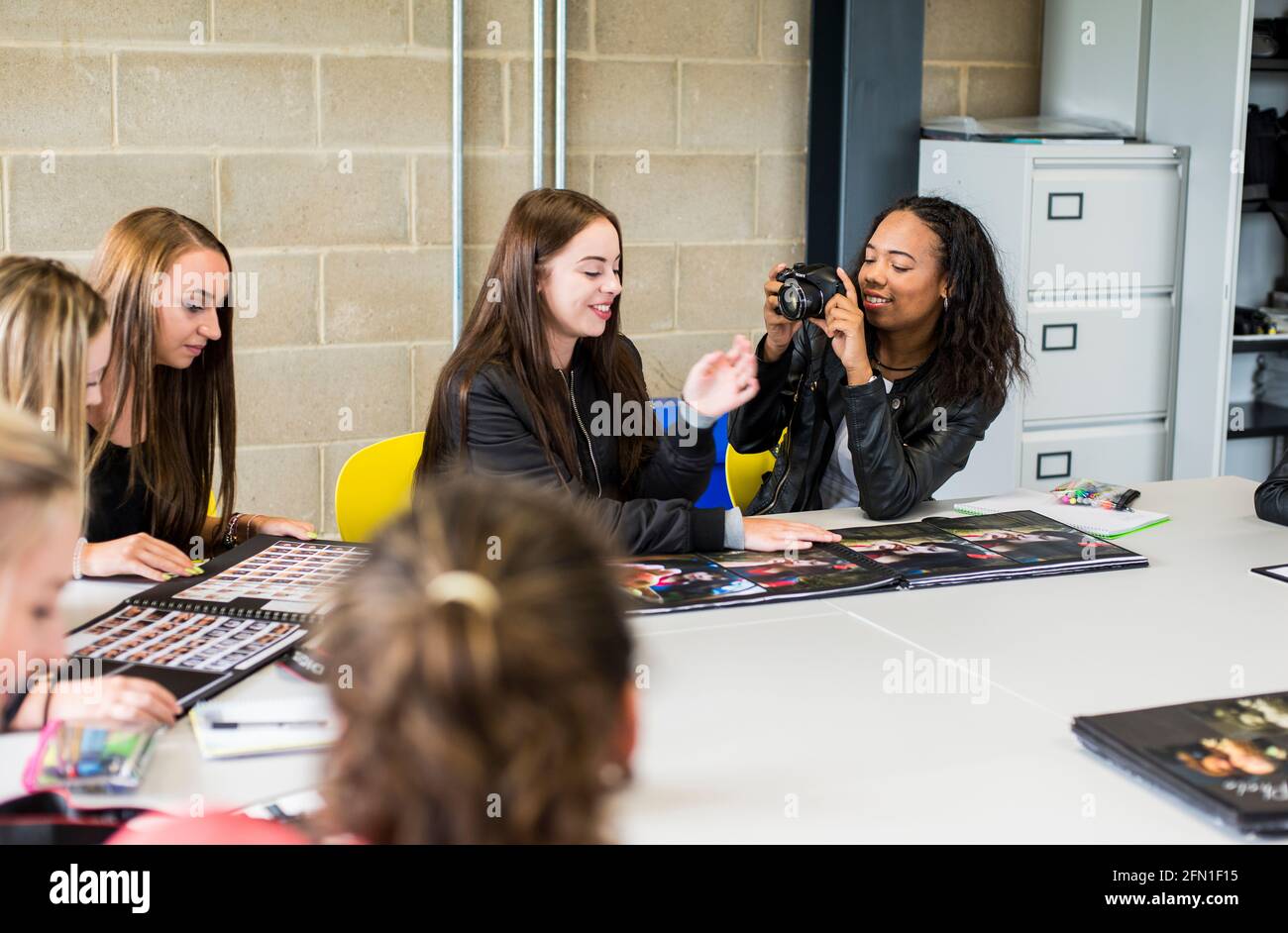 Multicultural sixth form students, young people in education, group of young female students in 6th form, students interacting in photography class Stock Photo