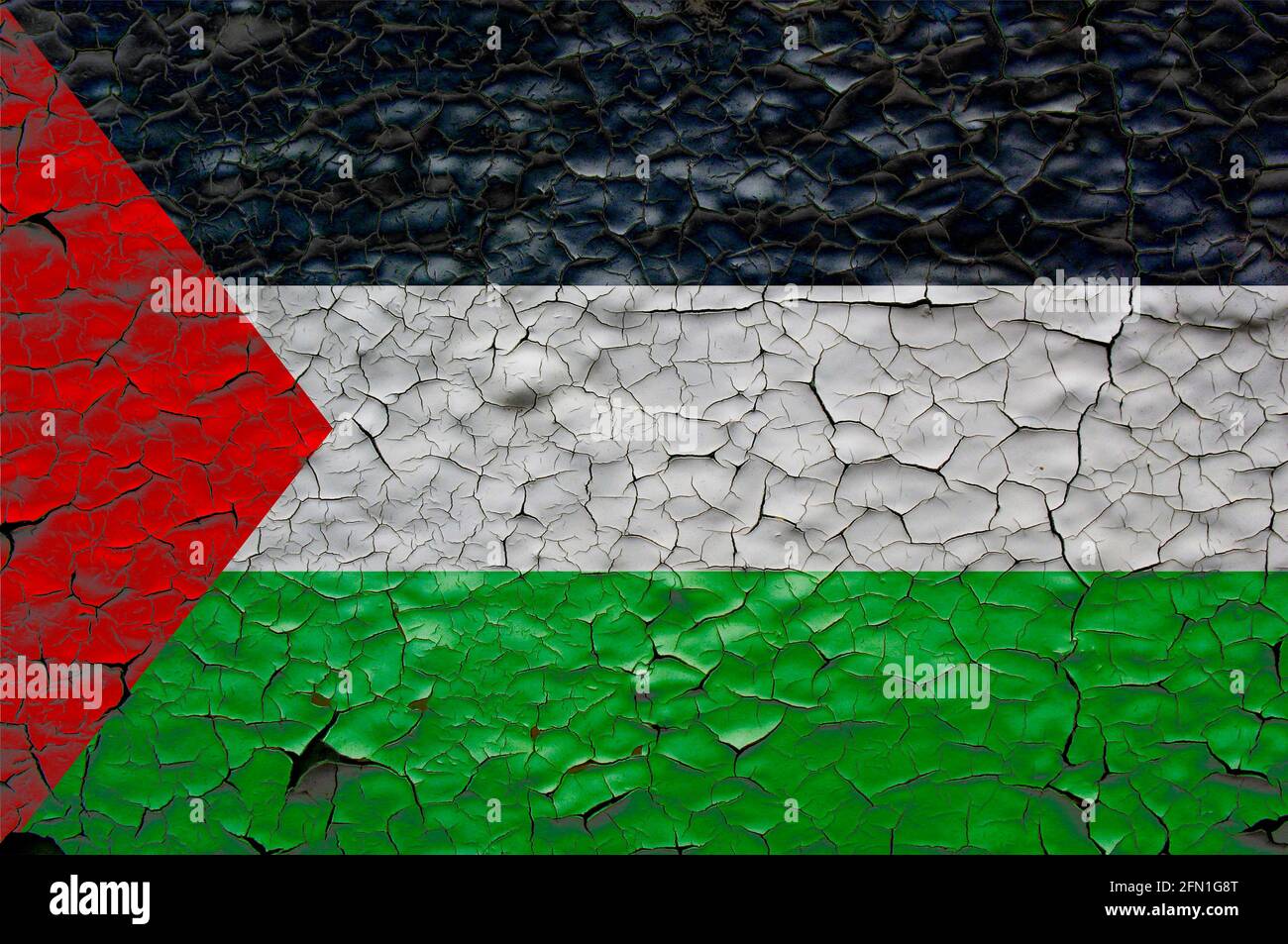 palestine flags painted over cracked concrete wall. Stock Photo