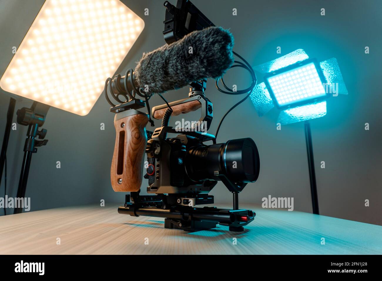 Full frame camera with external monitor, mic, and handheld film-making rig. Stock Photo