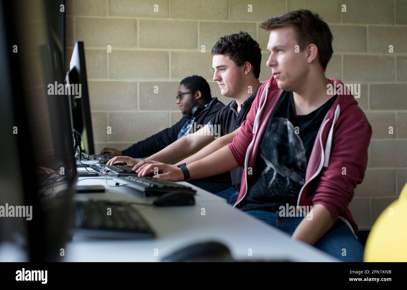 Sixth Form Students, Young people in education, two teenagers collaborating at screens, 3 young males in 6th Form working together Stock Photo