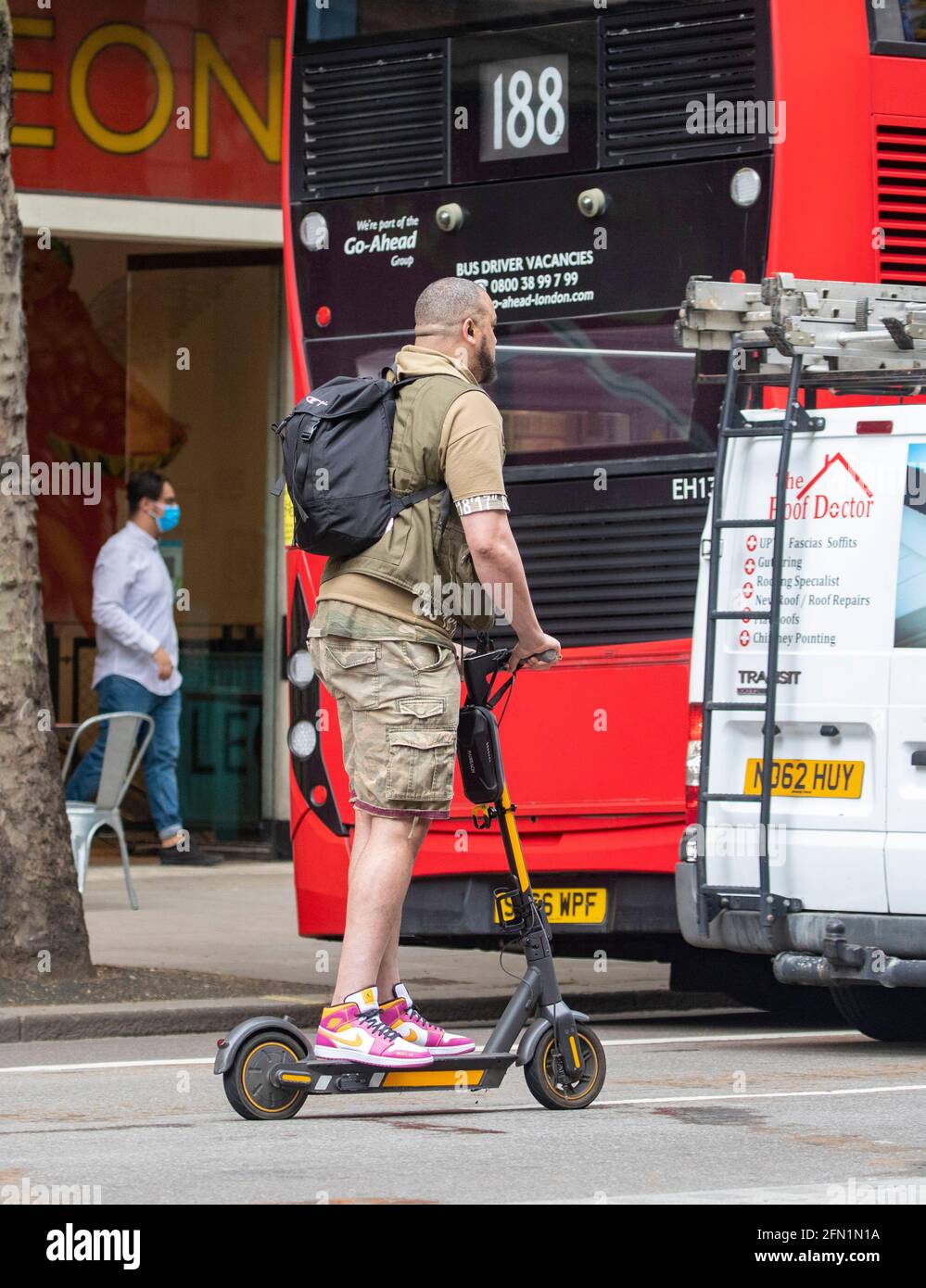 Man on electric scooter hi-res stock photography and images - Alamy