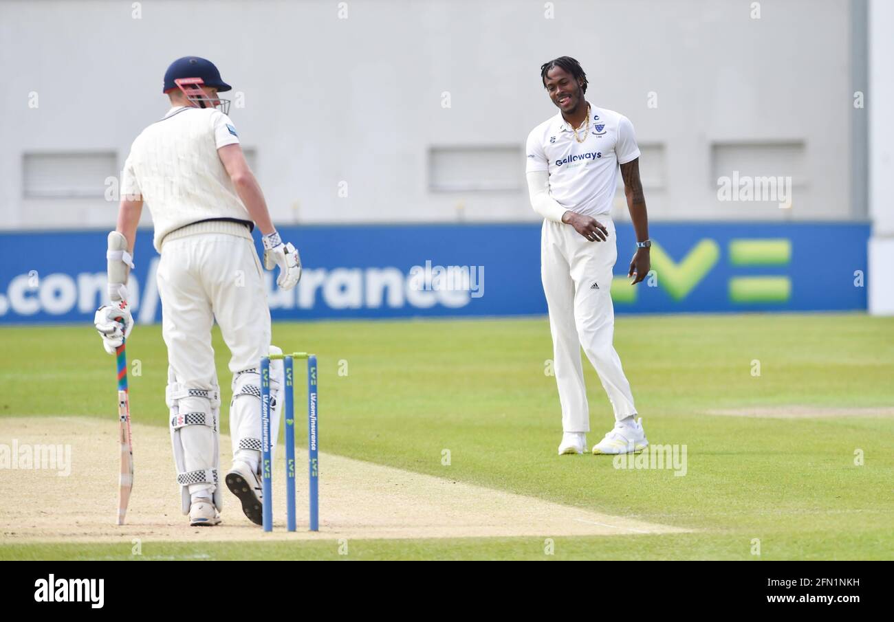 Hove, UK. 13th May, 2021. Sussex's Jofra Archer is all smiles as he bowls against Kent on the first day of their LV= Insurance County Championship match at The 1st Central County Ground in Hove . : Credit: Simon Dack/Alamy Live News Stock Photo