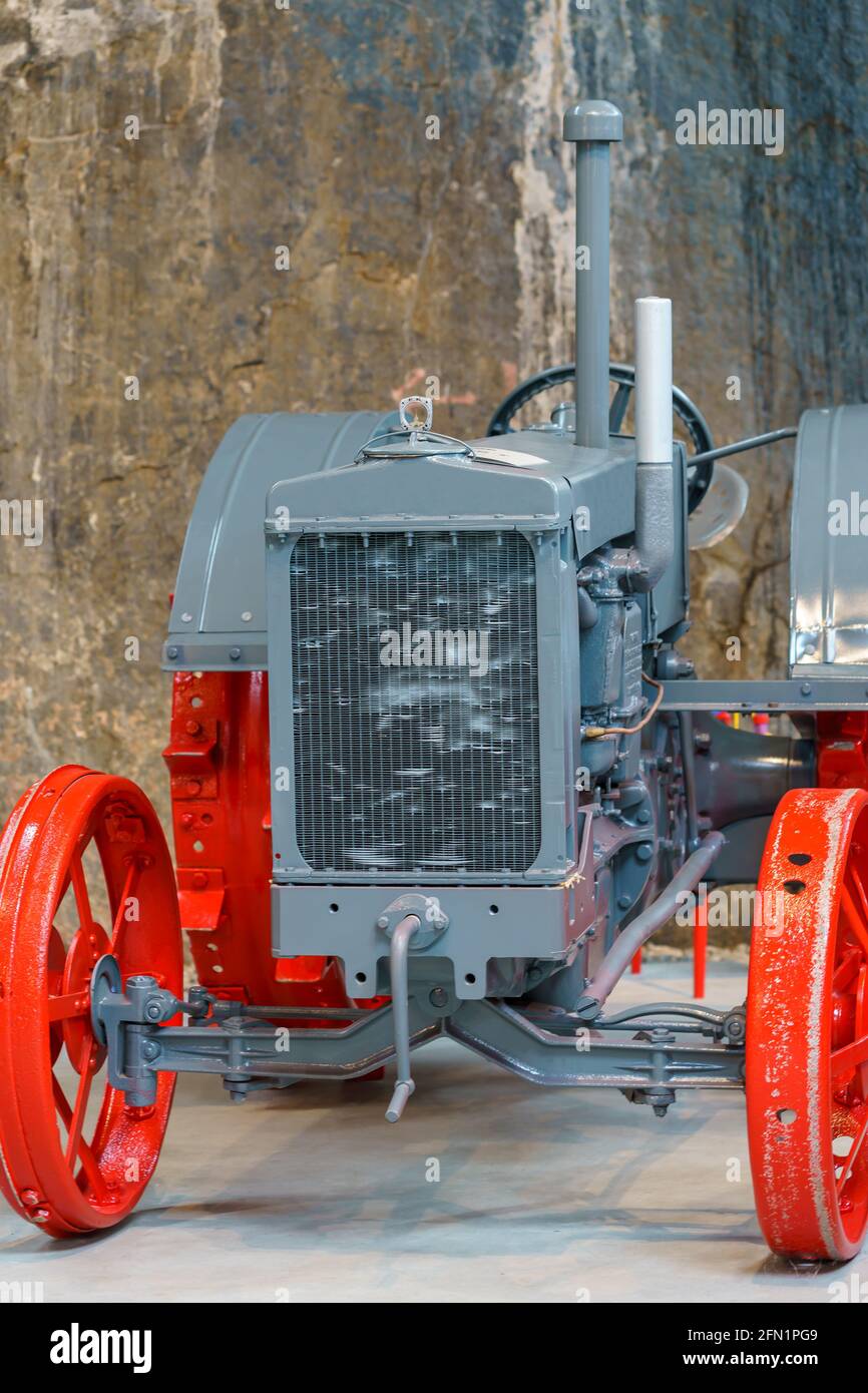 BYRKJEDAL, NORWAY- 2020 SEPTEMBER 07. Old grey vintage tractor with red steel wheels. Stock Photo