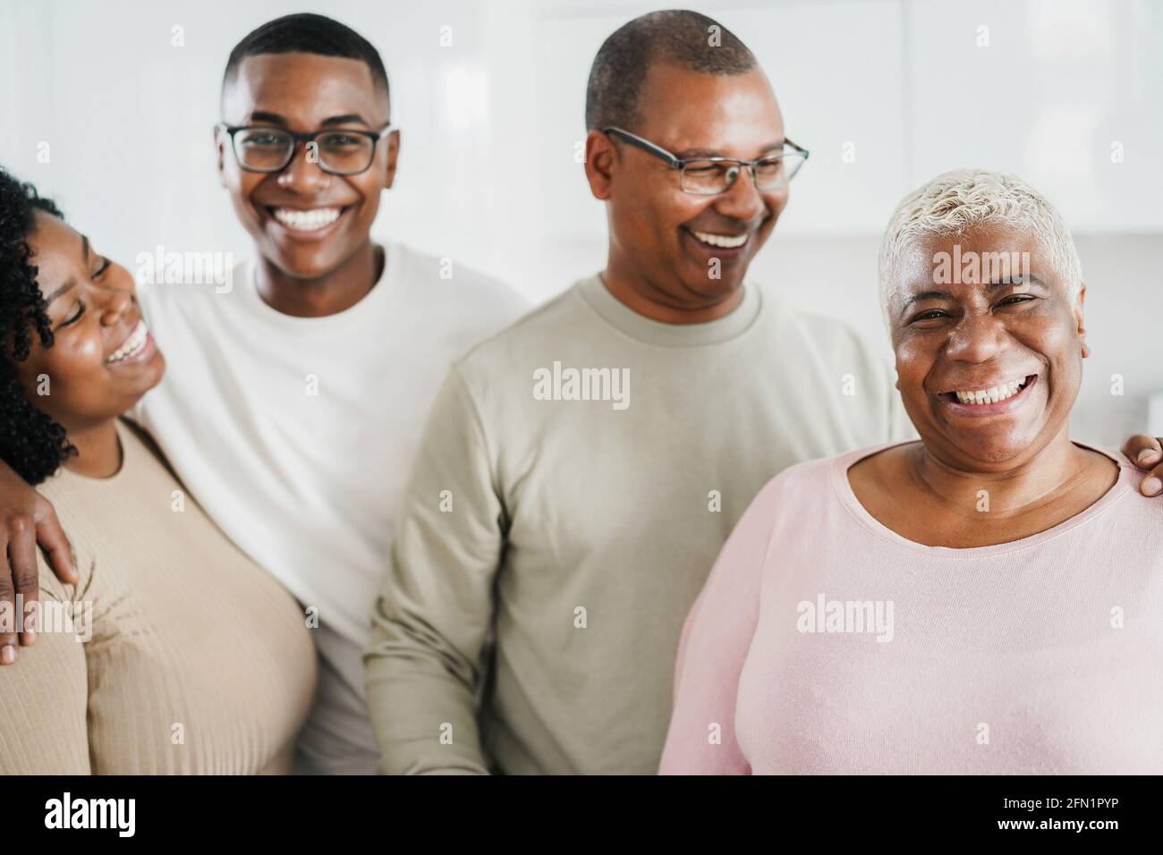Happy black family smiling in front of camera at home - Focus on mother ...