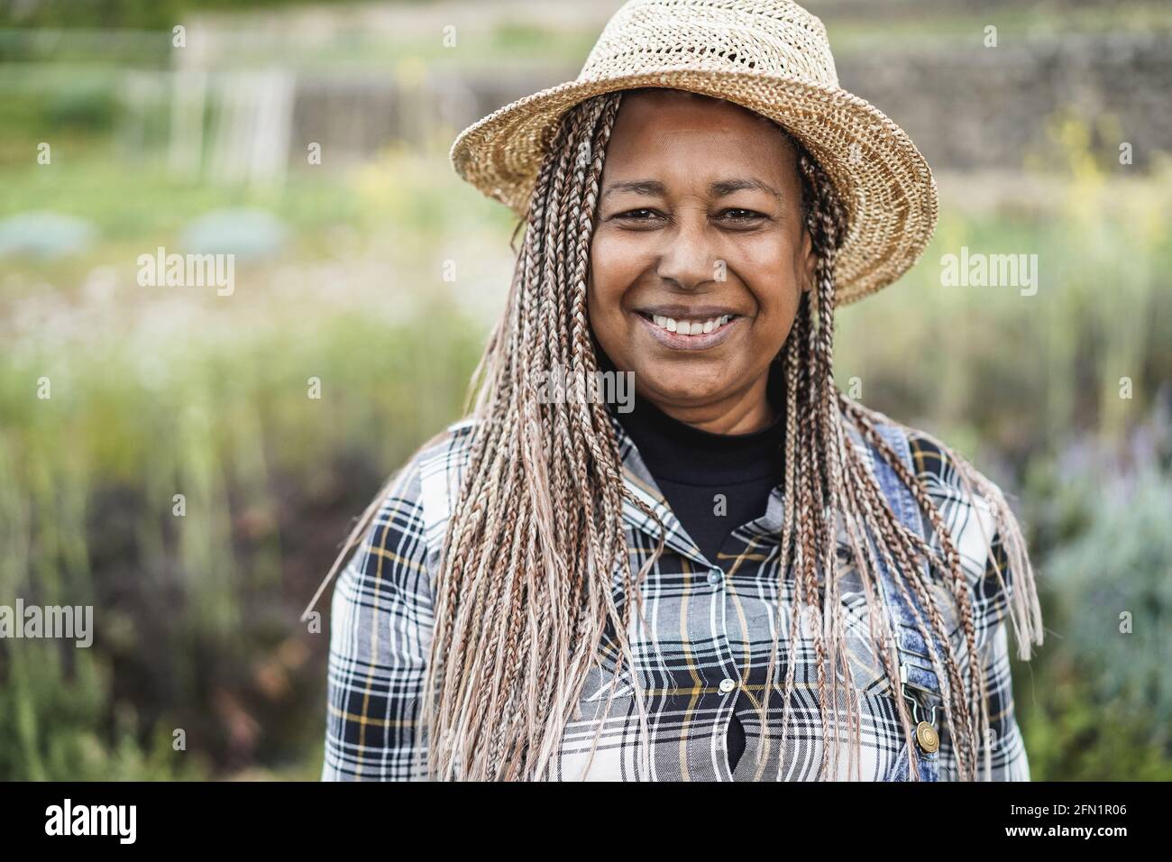 African farmer smiling on camera during harvest period - Focus on face ...