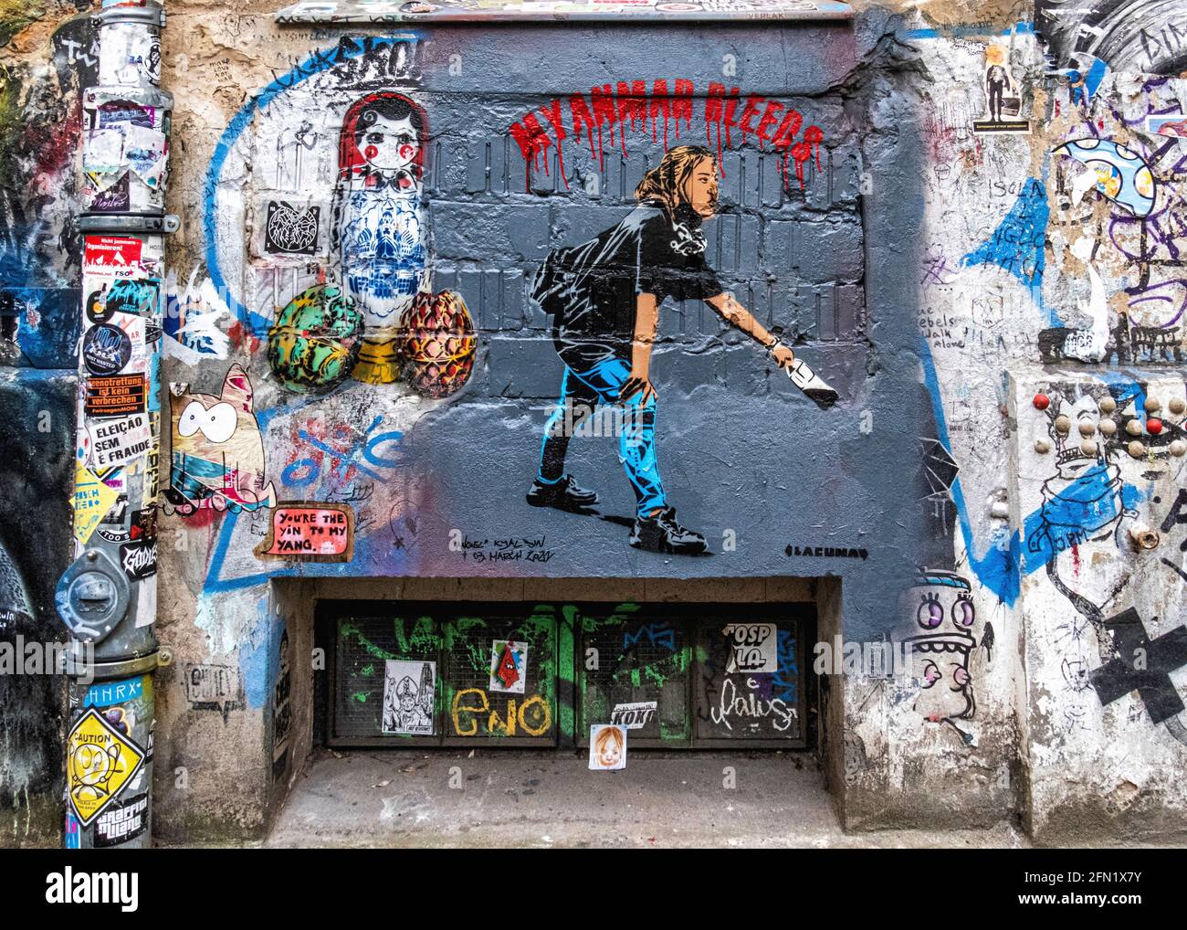 Street art & graffiti on dilapidated wall of Haus Schwarzenberg art & culture venue 39 Rosenthaler Strasse, Mitte, Berlin,Germany. Myanmar bleeds Art Stock Photo