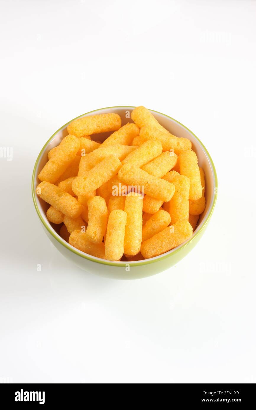 Cheese flavored puffed corn snacks in a bowl Stock Photo