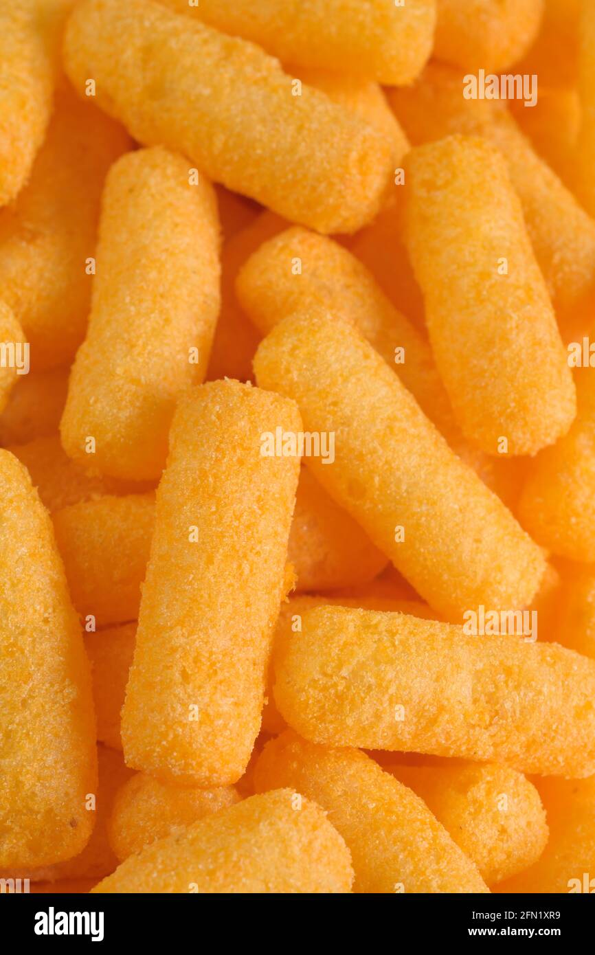 Cheese flavored puffed corn snacks in a bowl Stock Photo