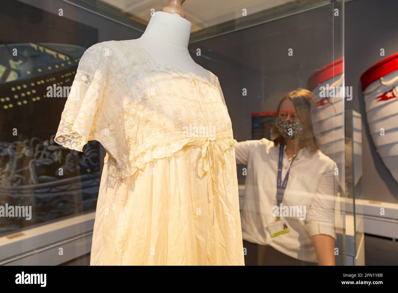 Worcester, UK. 13th May, 2021. Claire Cheshire, curator at Worcester City Art Gallery and Museum, takes a final look at a nightdress worn by a woman on the night the Titanic sank in 1912, as the museum launches an exhibition Titanic: Honour and Glory. The exhibits include genuine artefacts and memorabilia from the 1997 movie, and will be on show from Monday 17th May. Peter Lopeman/Alamy Live News Stock Photo