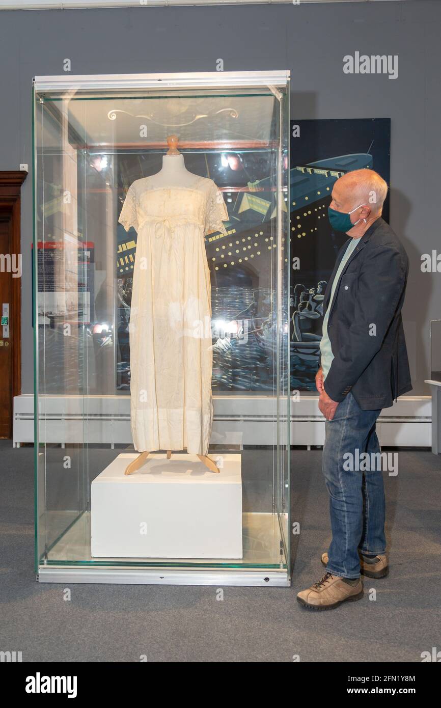 Worcester, UK. 13th May, 2021. Pete Cartridge, a Worcester city decendant of a Titanic victim, takes a look at a nightdress worn by a woman on the night the Titanic sank in 1912, as Worcester Art Gallery and Museum launches an exhibition Titanic: Honour and Glory. The exhibits include genuine artefacts and memorabilia from the 1997 movie, and will be on show from Monday 17th May. Peter Lopeman/Alamy Live News Stock Photo