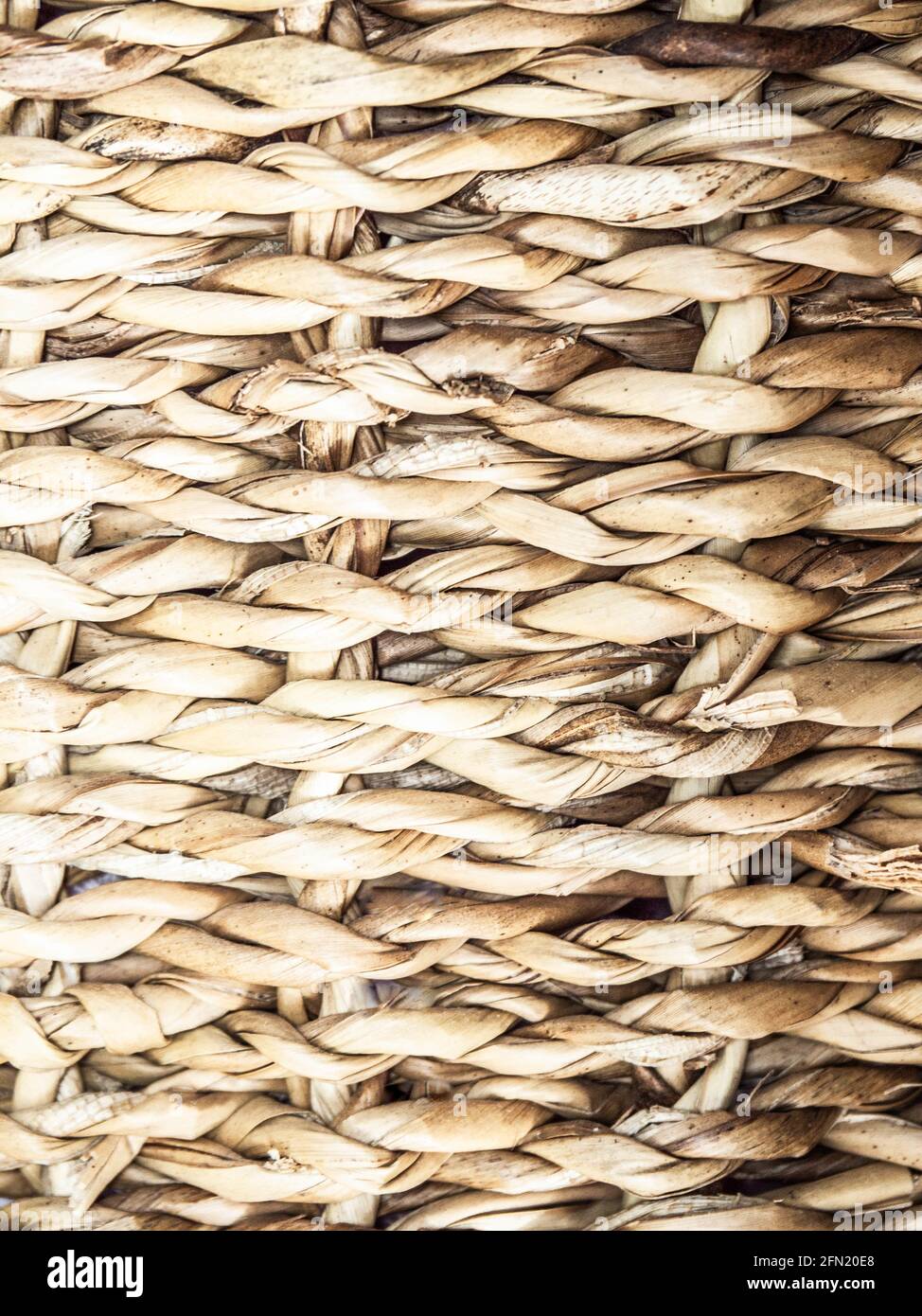 Wicker crafts basket background with shadows. Natural texture background. Stock Photo