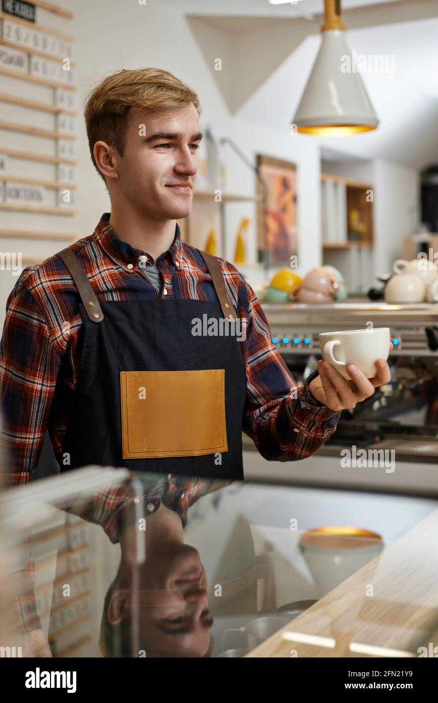 Male waiter with apron hi-res stock photography and images - Alamy