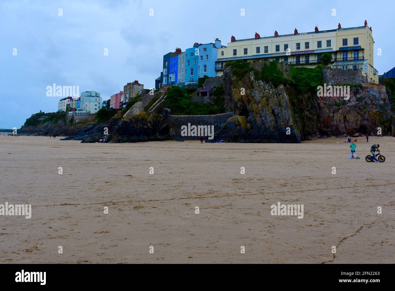 View of colourful houses / hotels on on top of a cliff overlooking the beach in Tenby. Stock Photo