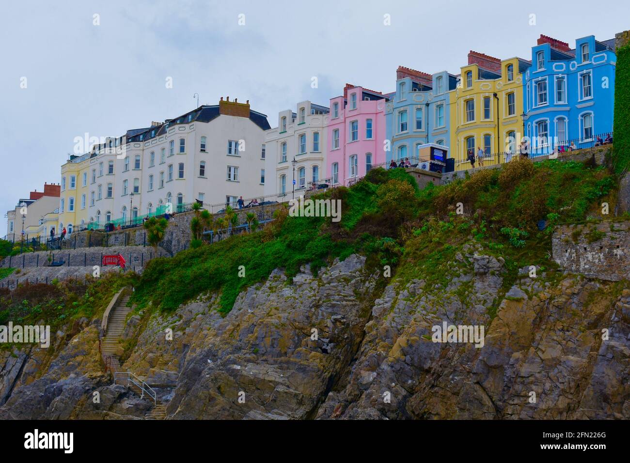 View of colourful houses / hotels on on top of a cliff overlooking the beach in Tenby. Stock Photo