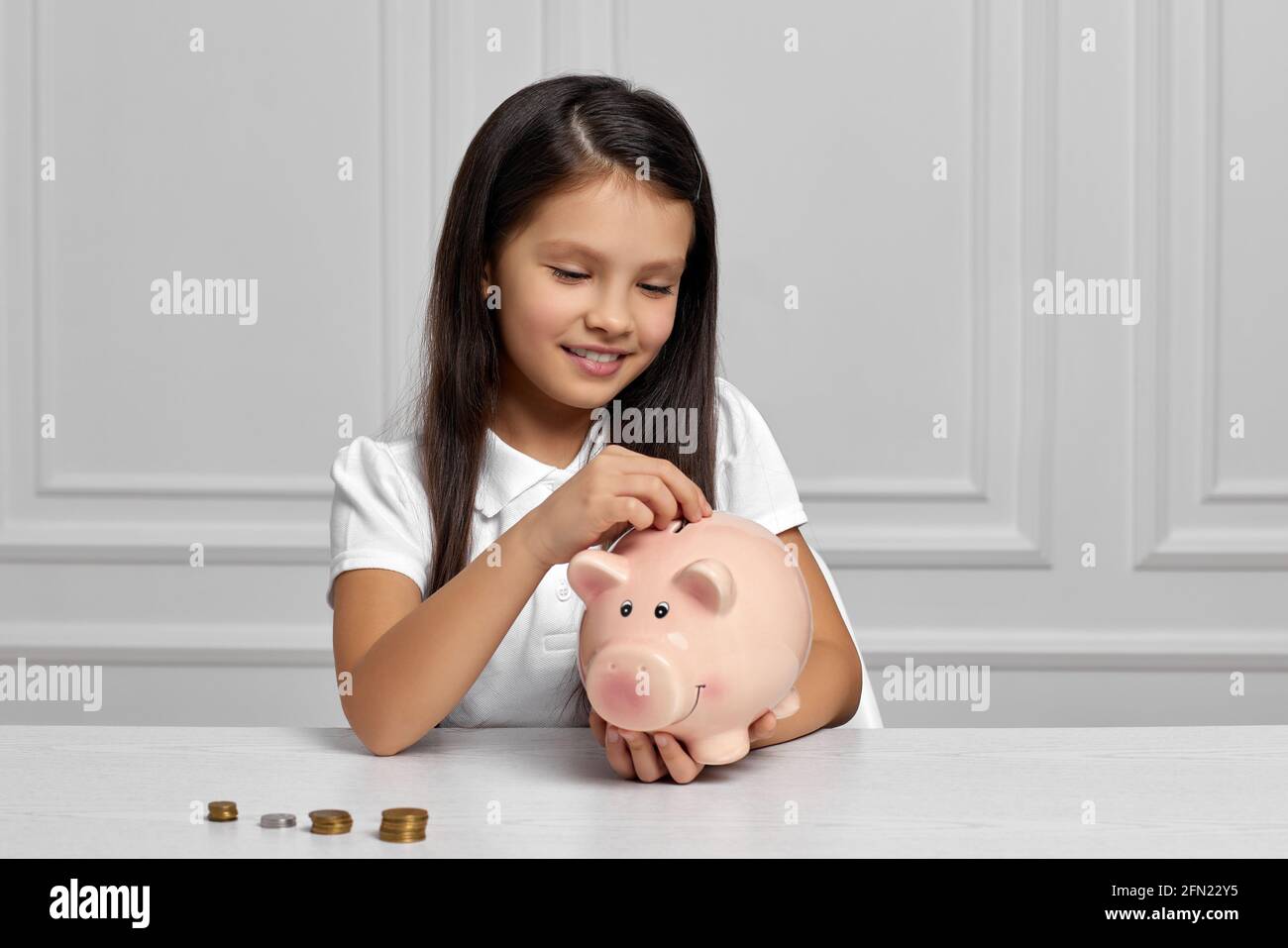 Little child girl with piggy bank at home Stock Photo - Alamy