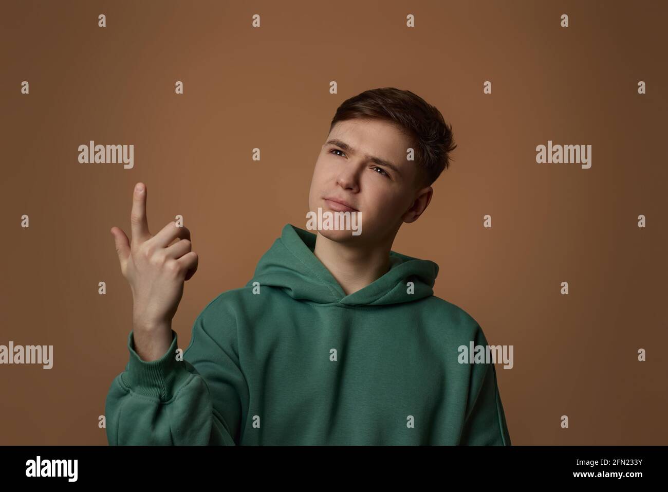 young handsome guy pointing finger up with successful idea Stock Photo