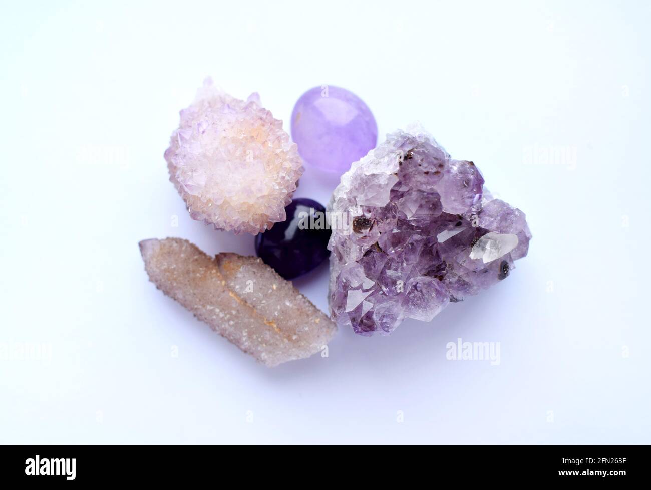 Amethyst purple natural stones in different varieties. Tumbled stones,  amethyst druse and cactus quartz crystals. Cactus quartz, known as spirit  quar Stock Photo - Alamy