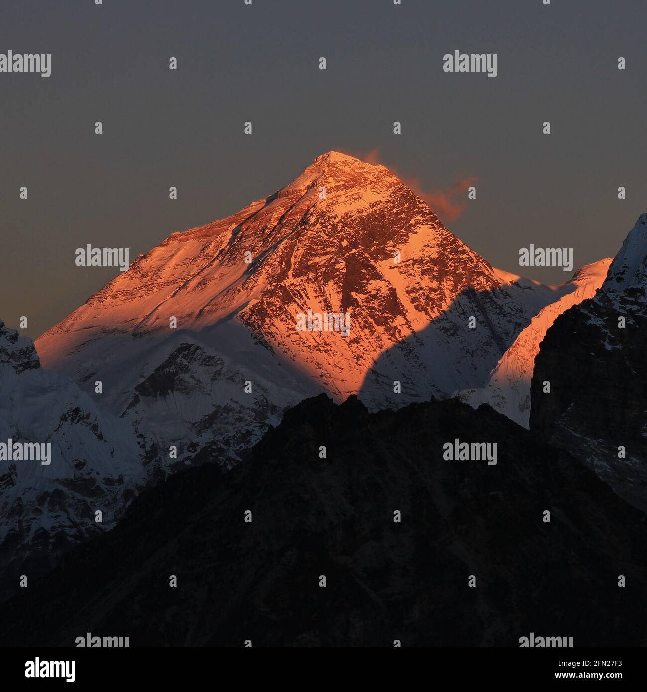 Highest mountain of the world at sunset. Illuminated peak of Mt Everest ...