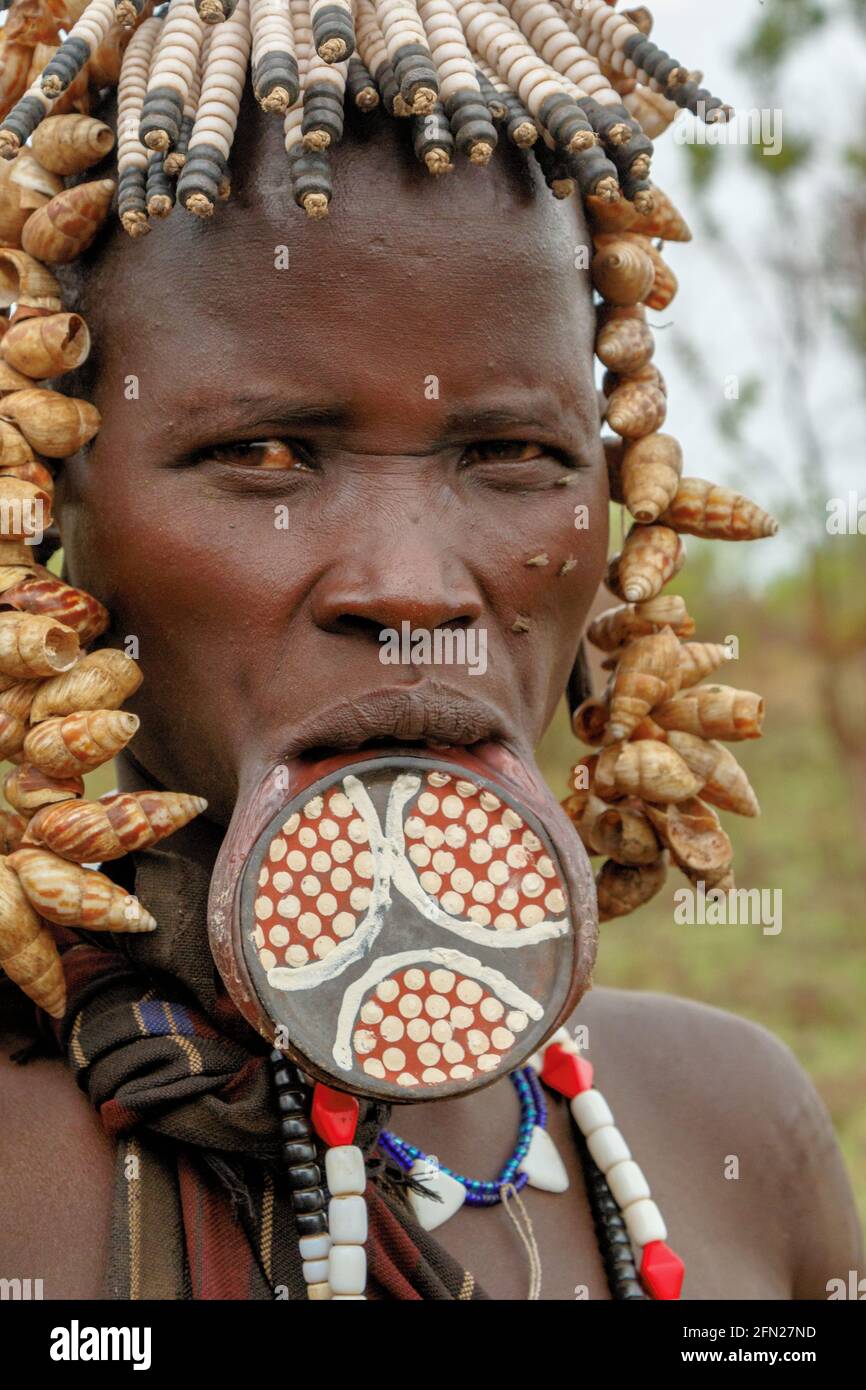 The lip plate is originally created by inserting a wooden peg into the