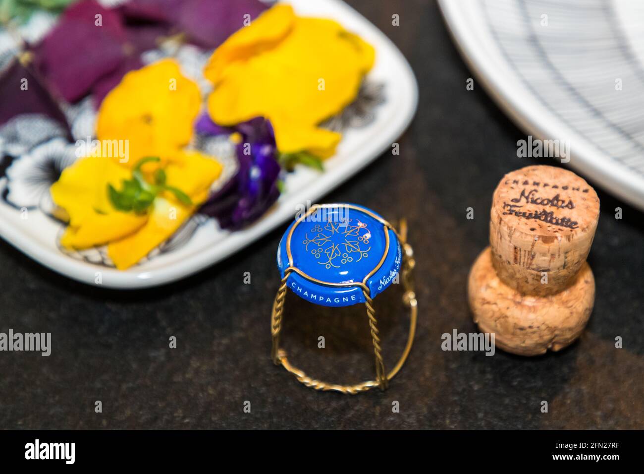 The emblematic logo of Nicolas Feuillatte Champagne also adorns the champagne lid and tells of grapes, grape leaves, people and a star for the first class Stock Photo