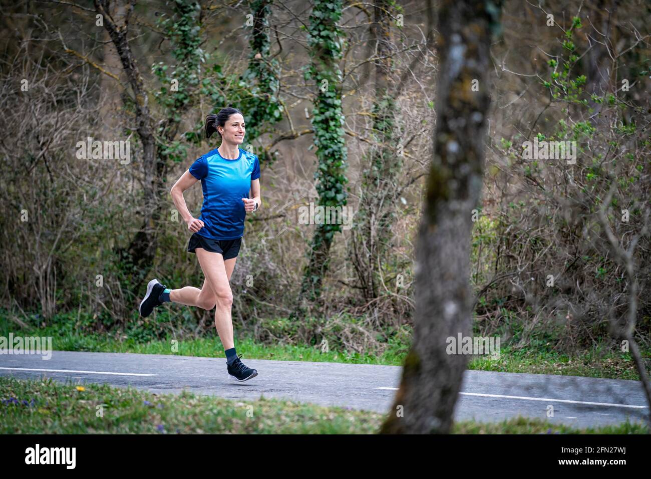 Girl running in nature, it is her healthy and free lifestyle. Stock Photo