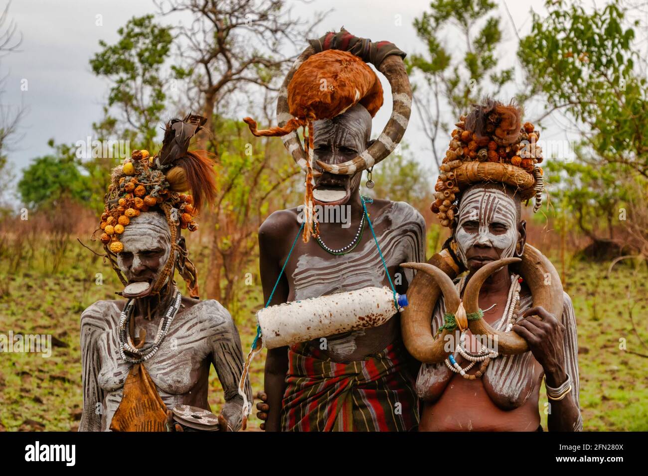 This trio of elders display the tribes' decorative look. OMO VALLEY, ETHIOPIA: MEET THE tribe where WOMEN are handed down to the next available man fo Stock Photo