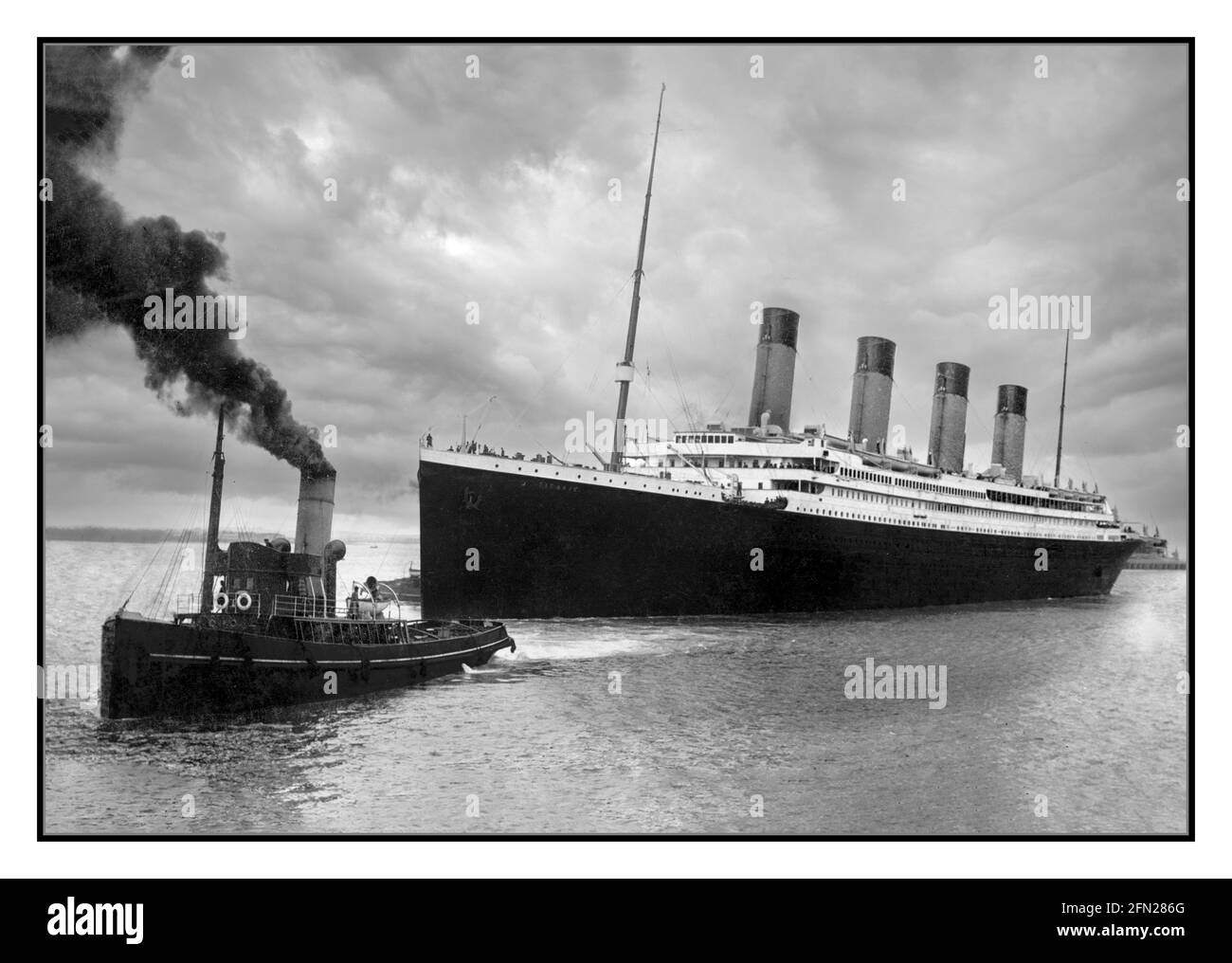 TITANIC 1912 Vintage historic RMS Titanic with the aid of a pilot tug leaving Southampton for her ill-fated maiden voyage on April 10, 1912. The White Star Dock, later known as Ocean Dock, opened in 1911. It was from here, Berth 44, that RMS Titanic was to leave Southampton on 10th April 1912. Stock Photo