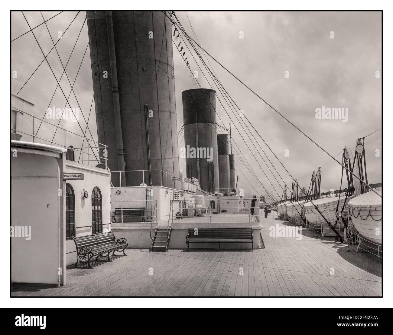 TITANIC LIFEBOATS DECK 1910s RMS Titanic First Class boat deck White Star Line with spotless decks, second class entrance on left with line of lifeboats on the right. Promotional photo before setting sail on its fateful voyage. Stock Photo