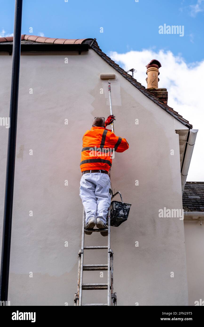 A Painter and Decorator Painting A House In Lewes, East Sussex, UK. Stock Photo