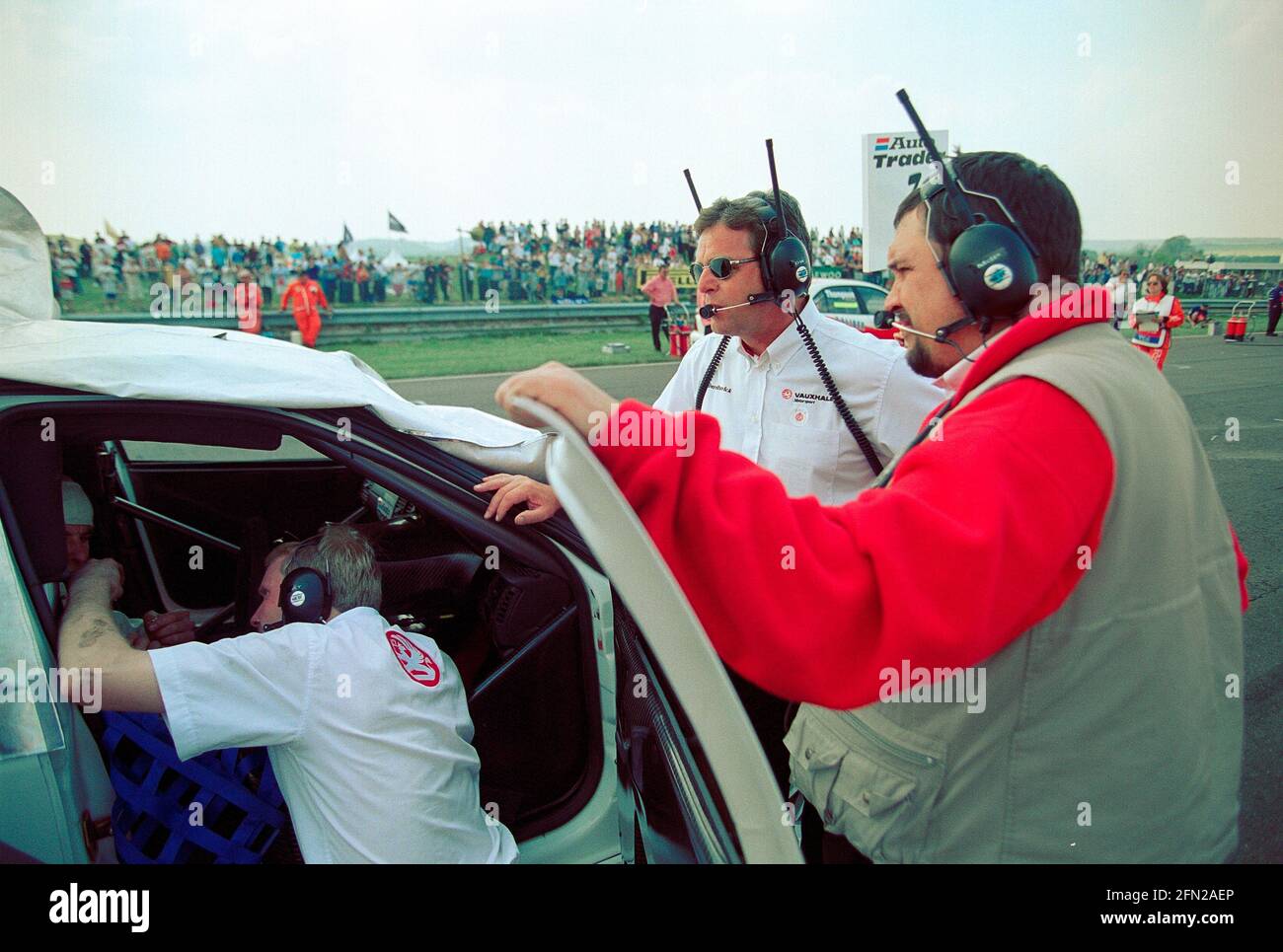 Derek Warwick overseeing Vauxhall Motorsport challenge of the British Touring Car championship of 1999 pictured on the grid at Thruxton Circuit as the cars and drivers prepare for the start of the race. Stock Photo