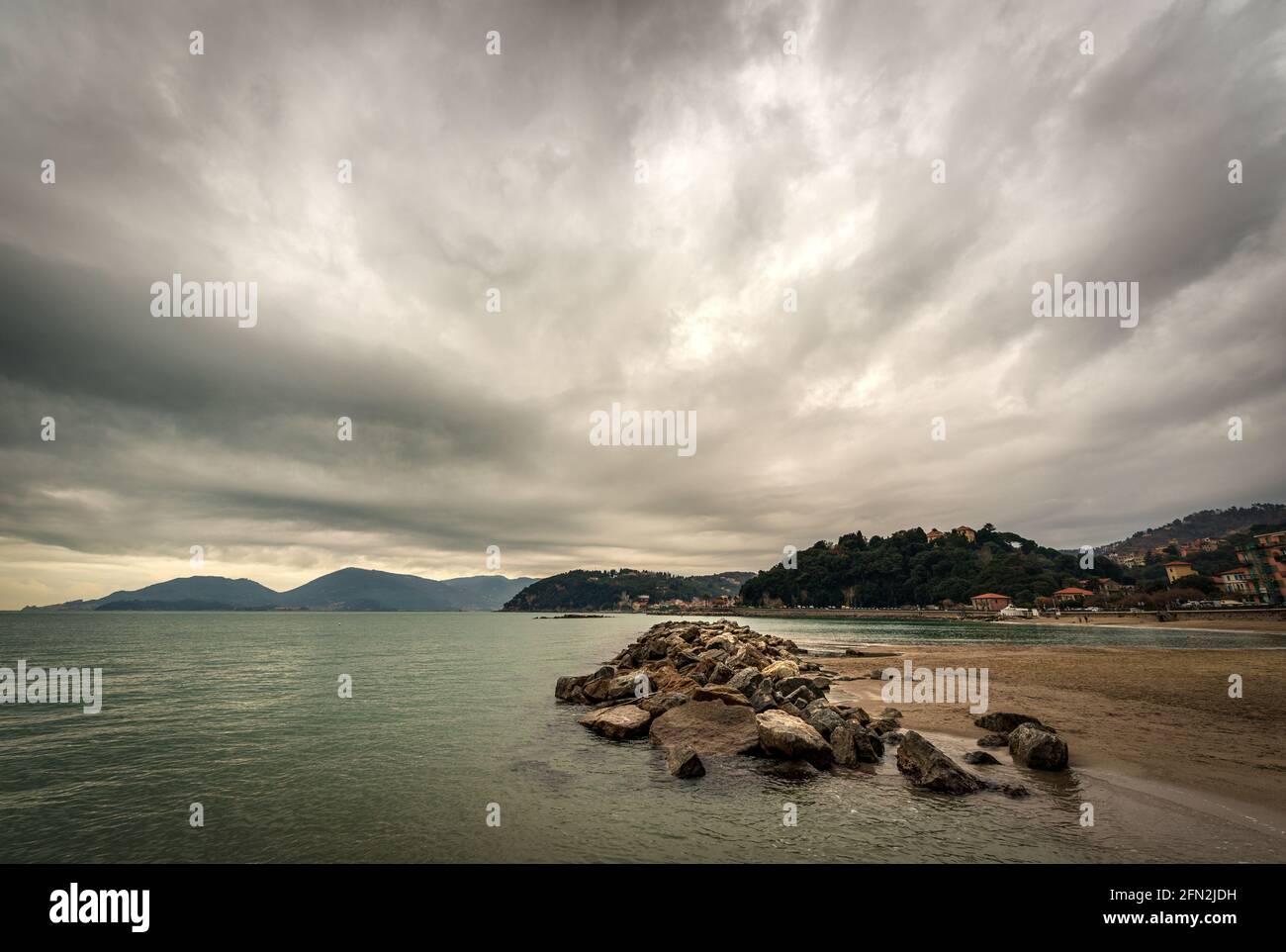 Beach and sea of the town of Lerici in winter, tourist resort in the Gulf of La Spezia, Liguria, Italy, Europe. On the horizon the San Terenzo village. Stock Photo