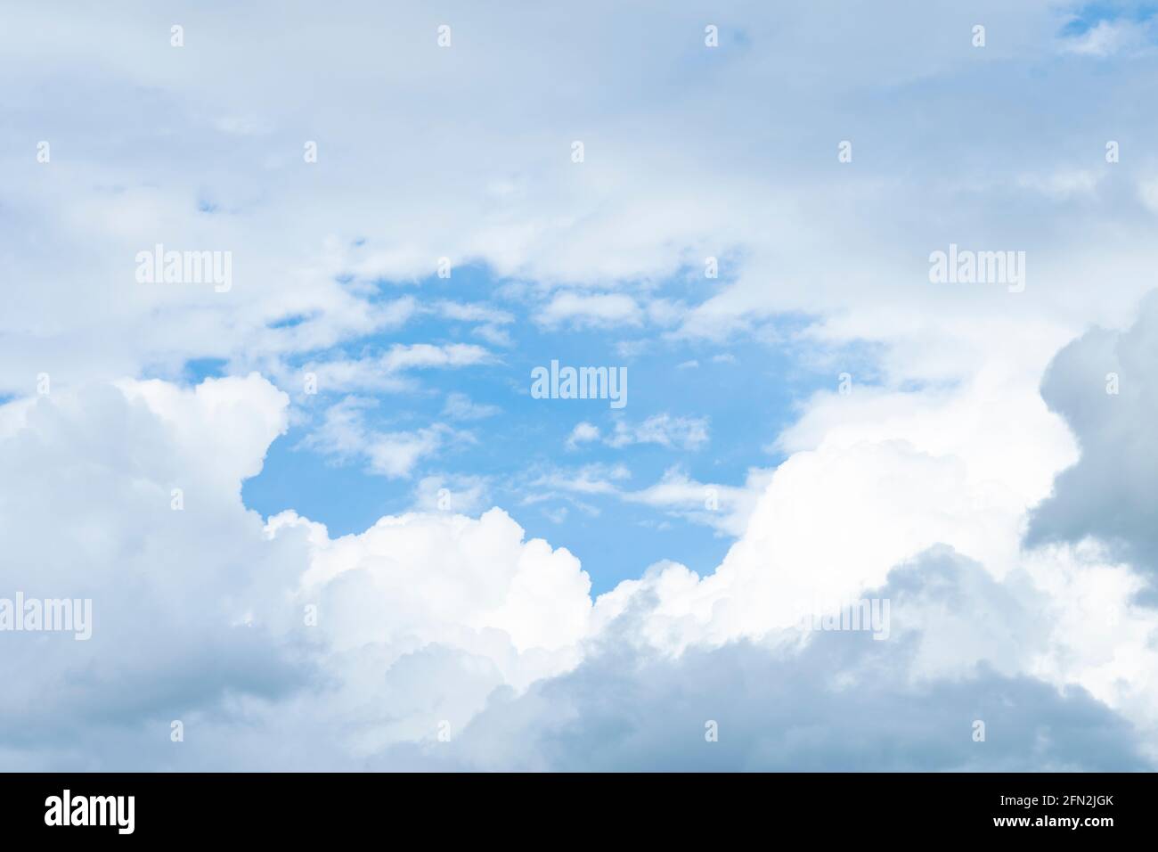 Stunning view of a blue sky with some fluffy clouds. Aerial shoot ...
