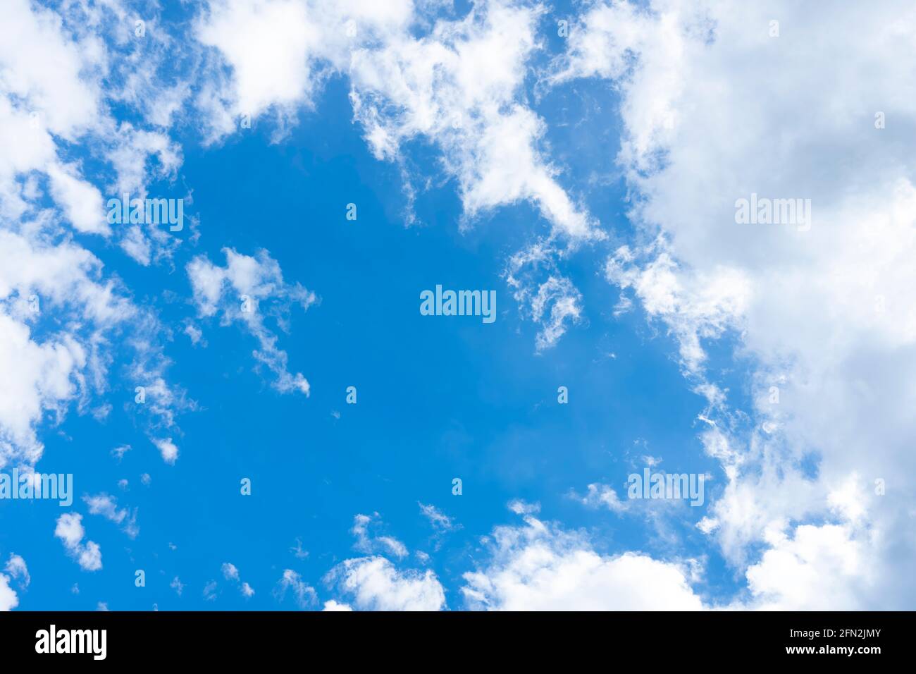 Stunning view of a blue sky with some fluffy clouds. Aerial shoot ...