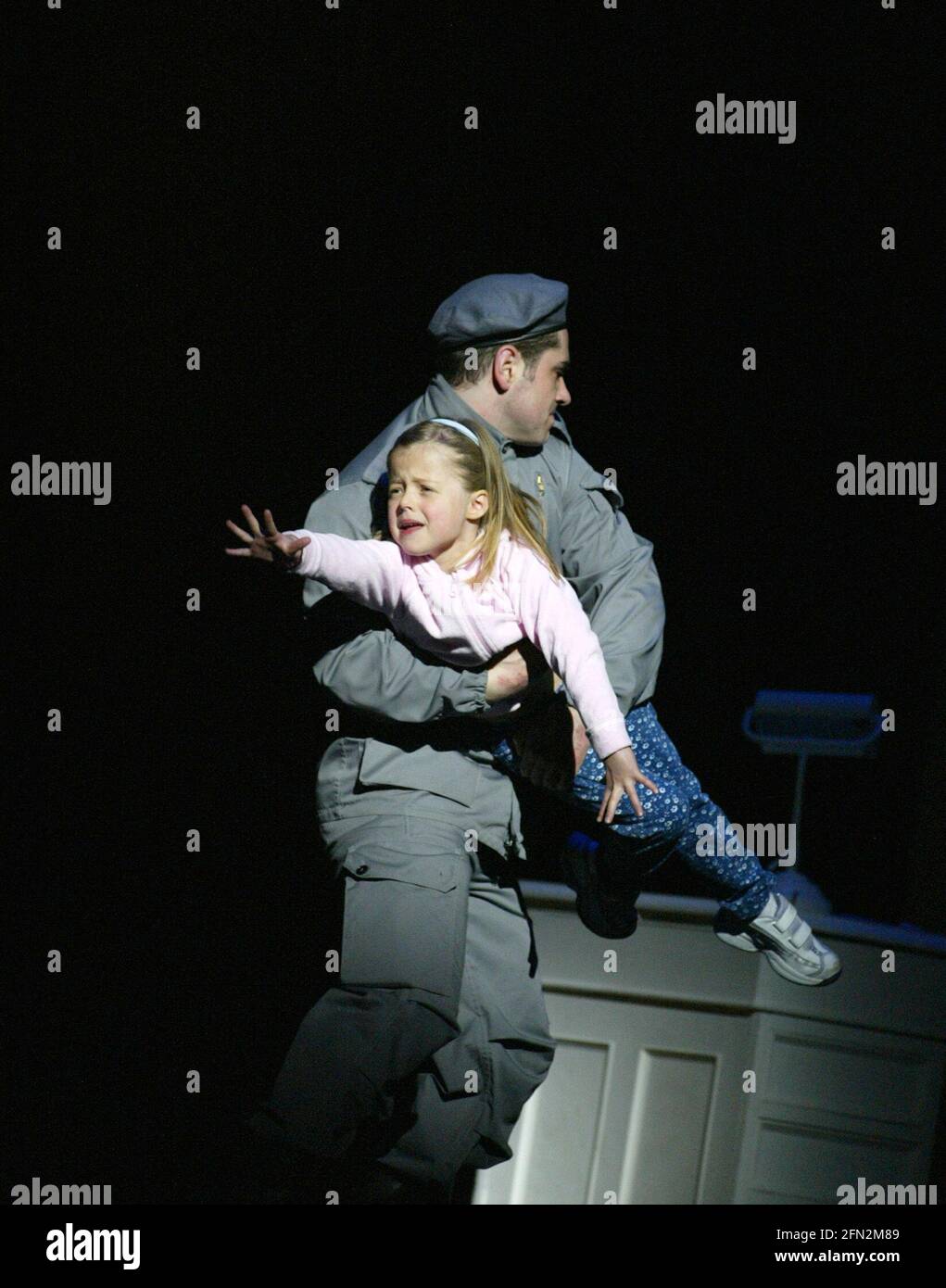 Offred's daughter is taken away in THE HANDMAID'S TALE at English National Opera (ENO), London Coliseum, London WC2  03/04/2003  music: Poul Ruders  libretto: Paul Bentley after the novel by Margaret Atwood  conductor: Elgar Howarth  design: Peter McKintosh  lighting: Simon Mills  choreographer: Andrew George  director: Phyllida Lloyd Stock Photo