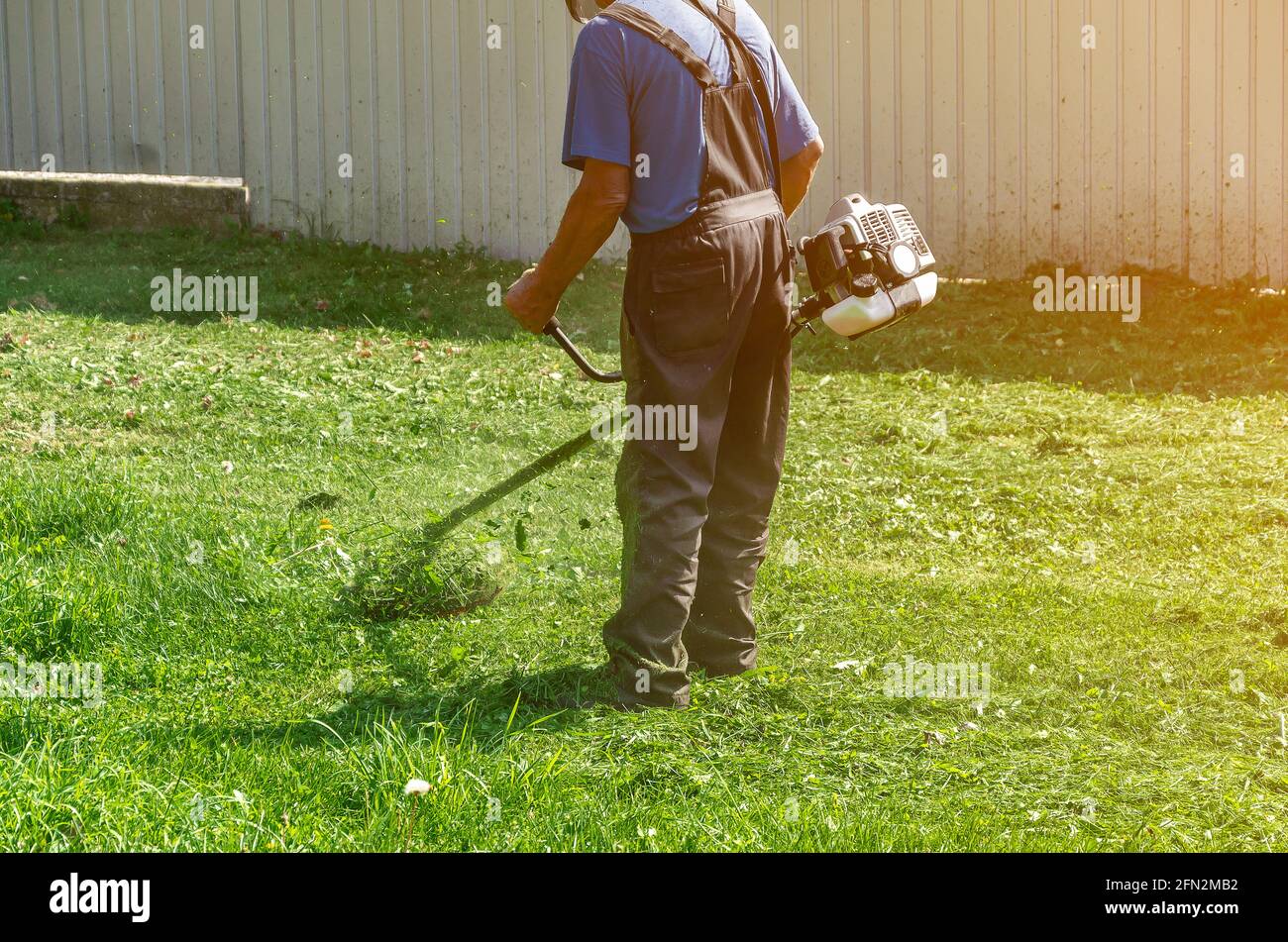 protective pants mows the green grass 