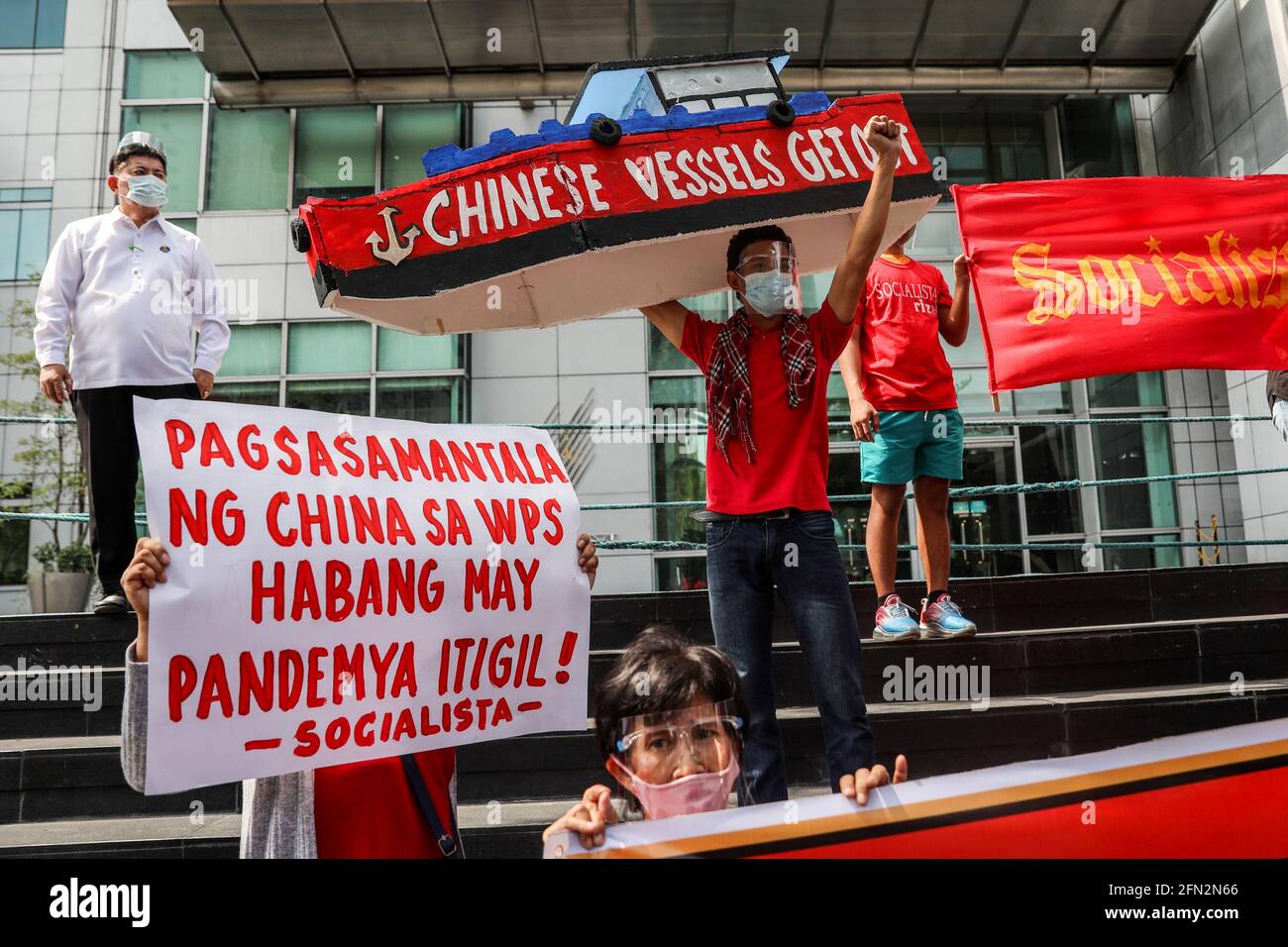 Filipino activists hold placards against China’s alleged continued occupation of islands in the South China Sea as they protest outside the Chinese Consulate in Makati City, metropolitan Manila. The protesters called on the government to act swiftly and uphold national sovereignty following China's growing presence in the disputed islands and reefs in South China Sea, where Chinese vessels believed to be operated by militia have been spotted within Philippine territorial waters. Philippines. Stock Photo