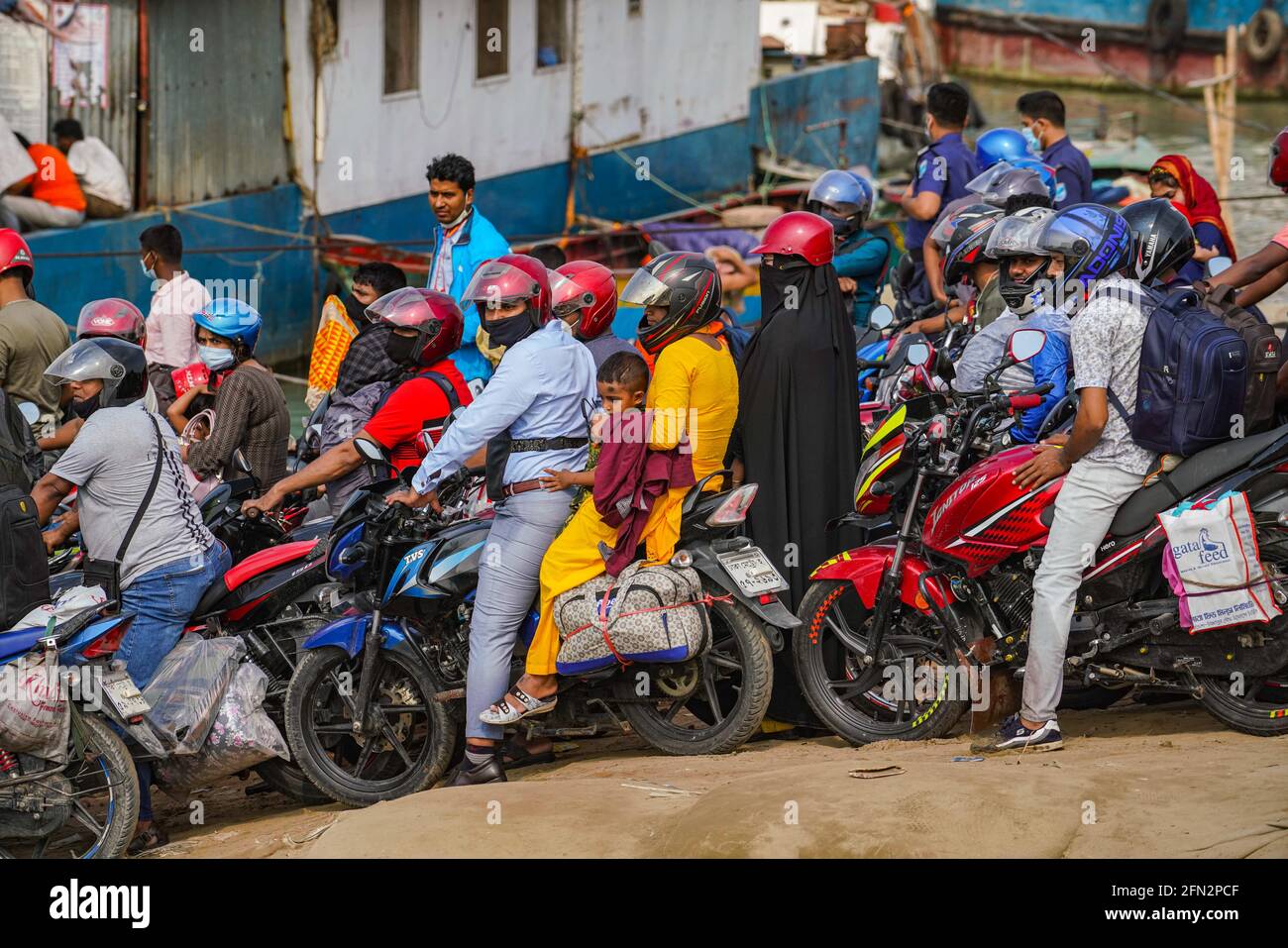 Munshiganj Bangladesh. 13th May 2021. People on motorcycles rush to board a ferry at Mawa Ferry Terminal to get home to celebrate Eid al Fitr in Shimuliya. Photo by Zabed Hasnain Chowdhury SOPA I Sipa