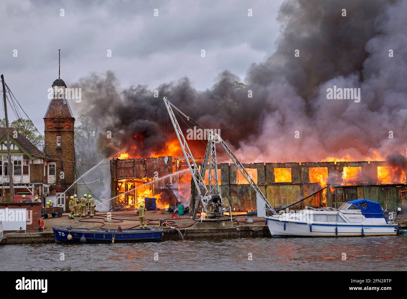 Fire brigade at the Platt's Eyot fire of 3 May 2021 which destroyed the boat shed of Otter Marine and the Dunkirk evacuation ship Lady Gay. The River Stock Photo