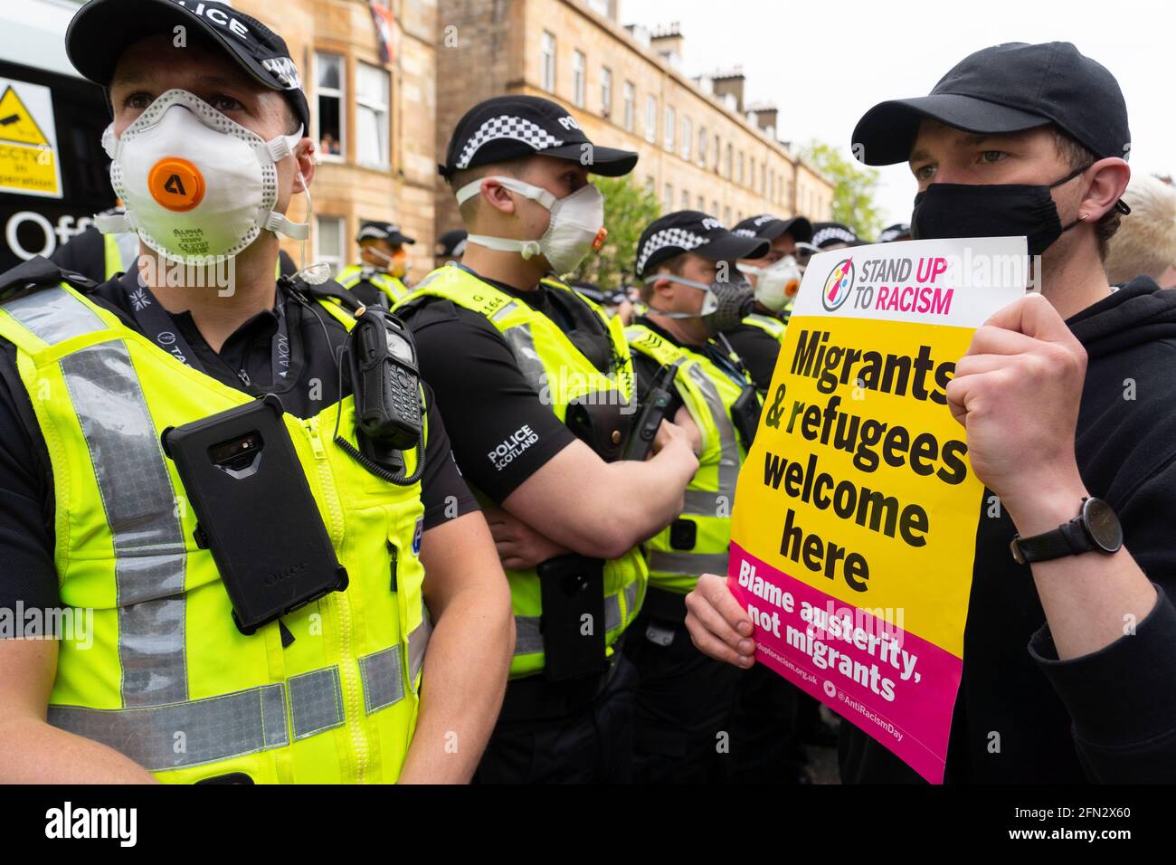 Glasgow, Scotland, UK. 13th May, 2021. At approx 5.30 pm police released two men from a Home Office detention vehicle. Accompanied by lawyer Aamer Anwar the men walked to a nearby mosque surrounded by hundreds of police and supporters who had previously been surrounding the vehicle and sitting on the street. Pic; Home Office immigration Enforcement vehicle containing two men is surrounded by protesters. Credit: Iain Masterton/Alamy Live News Stock Photo