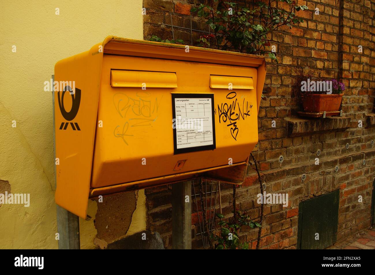 FRANKFURT, GERMANY - Apr 30, 2021: A public letterbox of Deutsche Post AG in Frankfurt Niederursel. Stock Photo