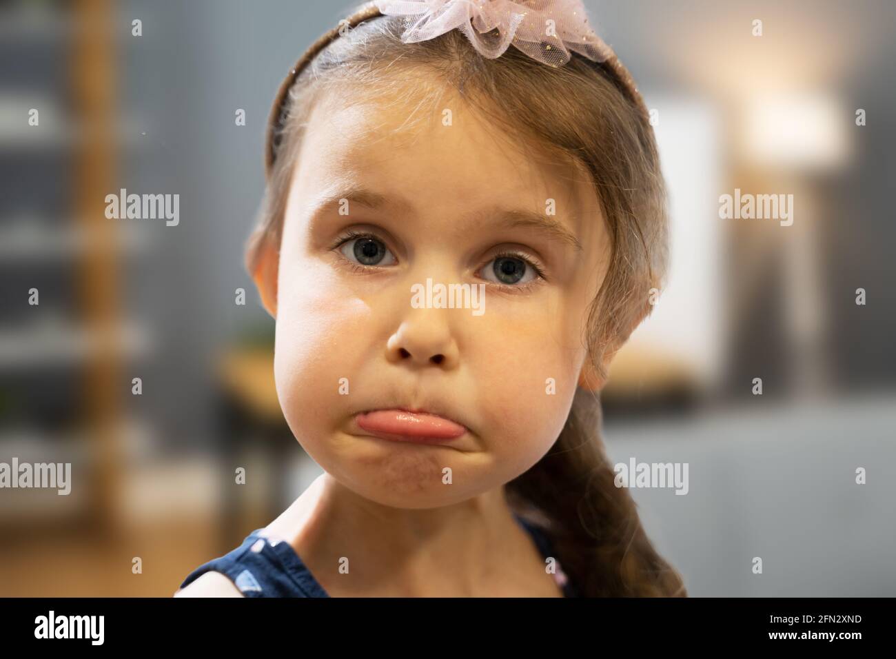 Sad Unhappy Little Girl Emotion. Kid Face Portrait Stock Photo
