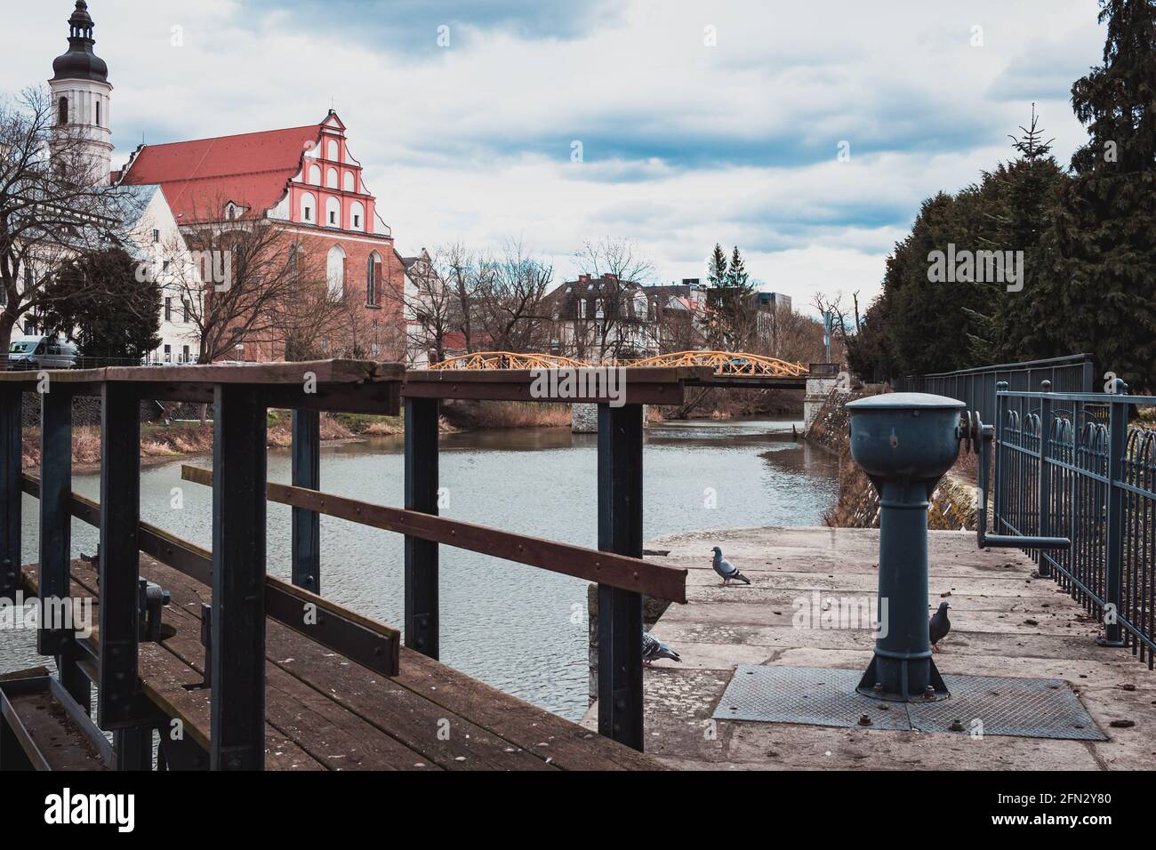 view of the water canal and surrounding buildings in Opole Stock Photo