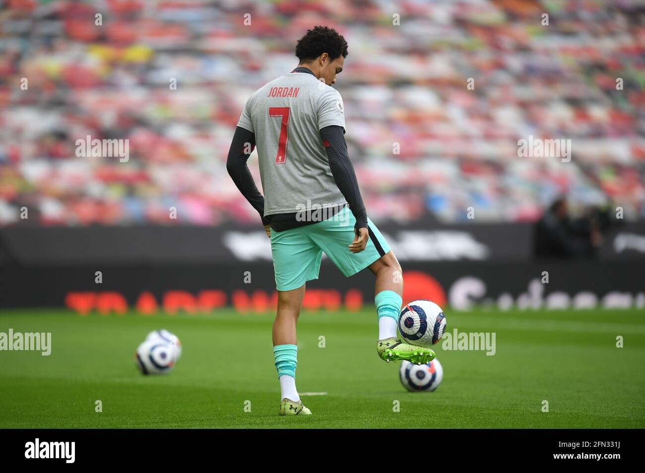 Liverpool's Trent Alexander-Arnold wearing a t-shirt paying tribute to 9-year-old fan Jordan Banks in the warm up before the Premier League match at Old Trafford, Manchester. Picture date: Thursday May 13, 2021. Stock Photo