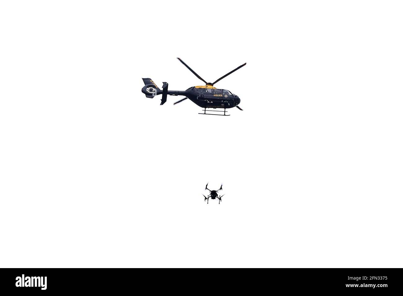 A police helicopter and drone as Manchester United fans protest against the Glazer family, the owners of Manchester United, ahead of their Premier League match against Liverpool at Old Trafford, Manchester. Picture date: Thursday May 13, 2021. Stock Photo