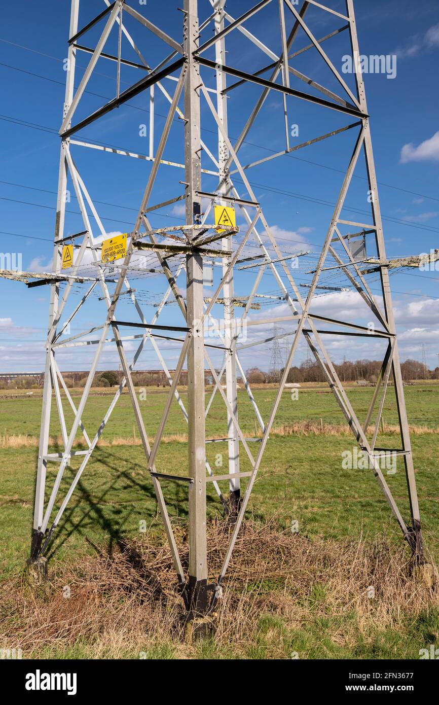 High voltage electricity pylon in sunlight Stock Photo