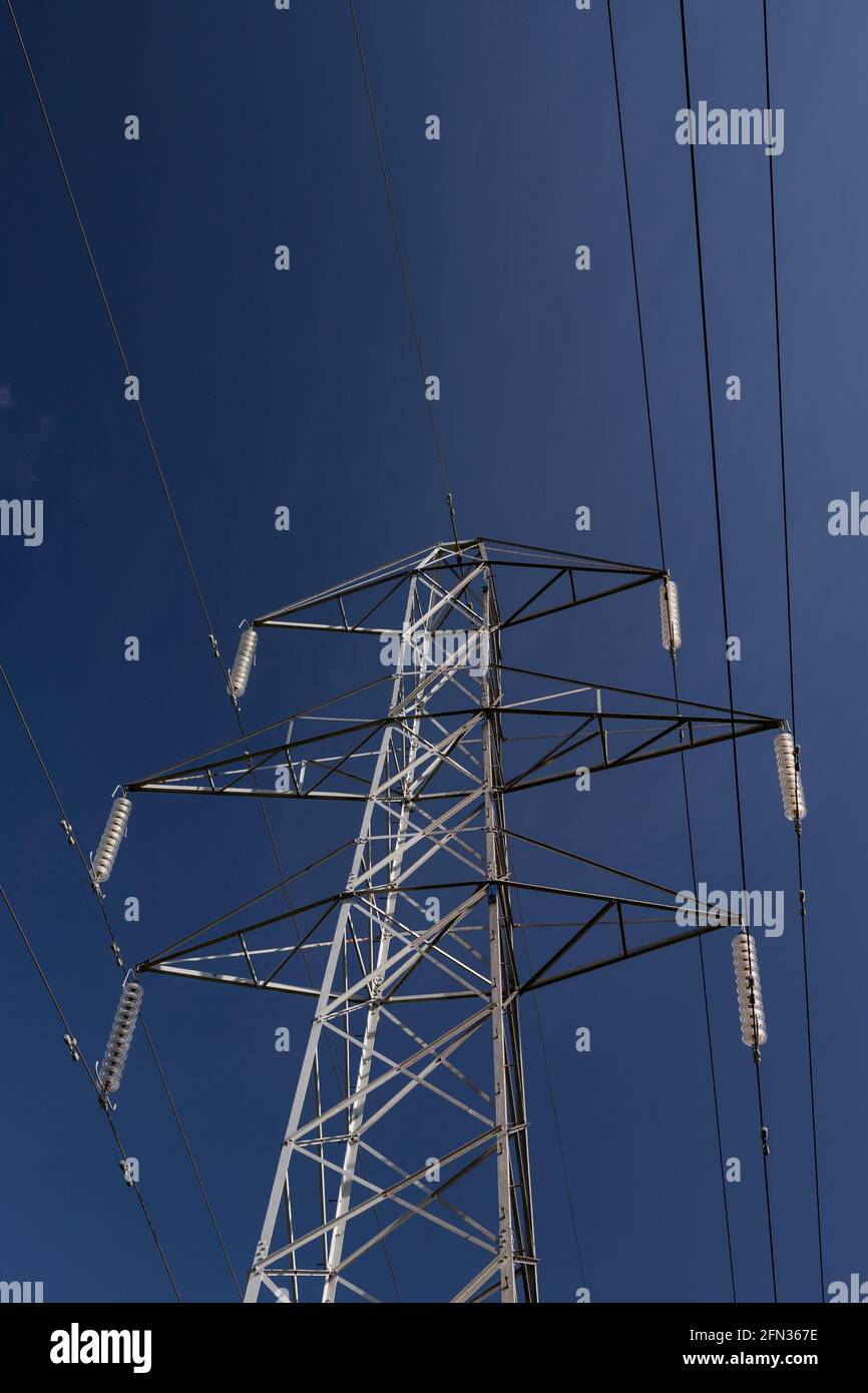 High voltage electricity pylon in sunlight Stock Photo