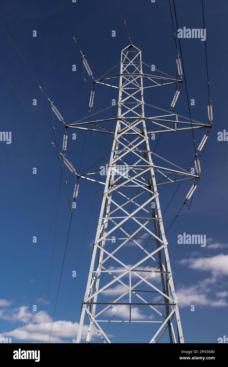 High voltage electricity pylon in sunlight Stock Photo