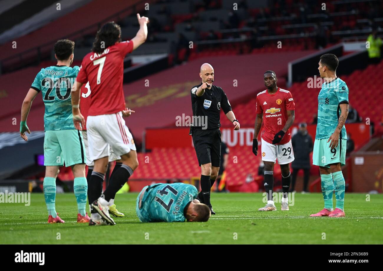 Referee Anthony Taylor points to the penalty spot before the decision is reversed after consulting the VAR during the Premier League match at Old Trafford, Manchester. Picture date: Thursday May 13, 2021. Stock Photo